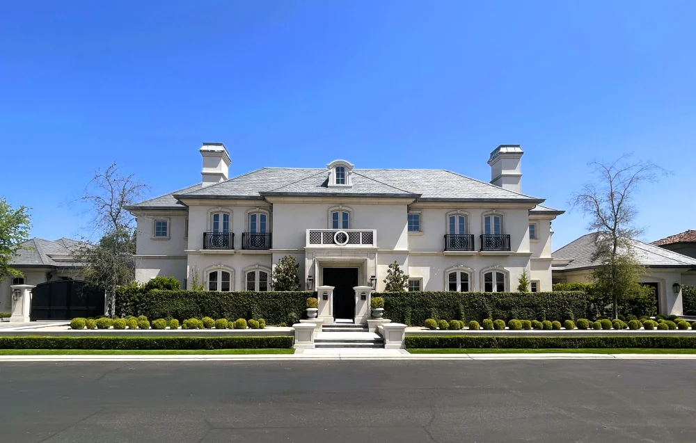 Front view of Campos Estate with a symmetrical facade and formal landscaping.